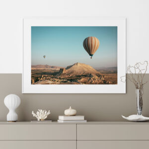 Hot air balloons over the mountains on a sunny day in a desert