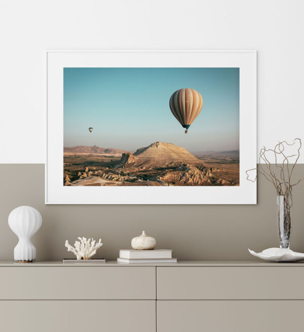 Hot air balloons over the mountains on a sunny day in a desert